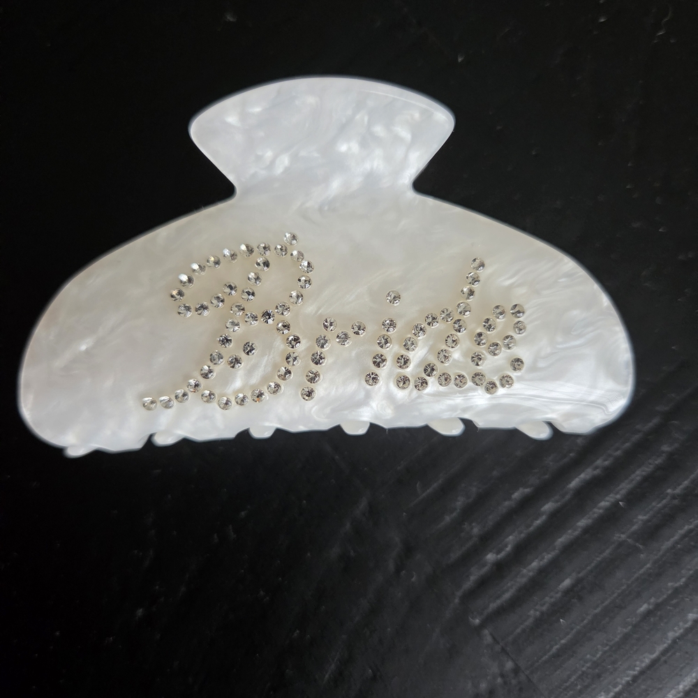 bebe Pearlized White Rhinestone Script Hair Claw